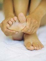 woman-massaging-her-own-feet